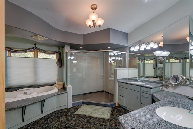 bathroom with two vanities, granite finish floor, a sink, and a stall shower