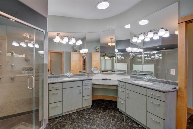 full bath with a stall shower, two vanities, and a sink