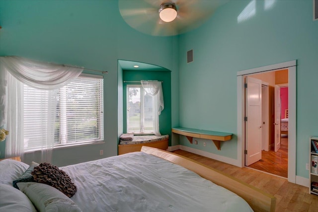 bedroom featuring ceiling fan, baseboards, and wood finished floors