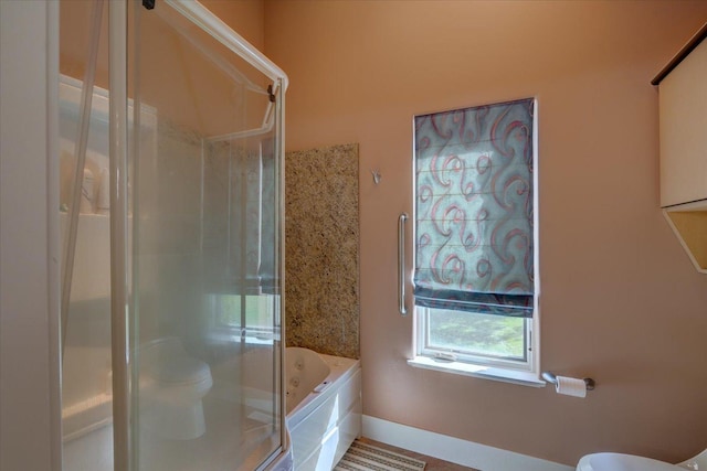 full bath with a stall shower, baseboards, a garden tub, and toilet