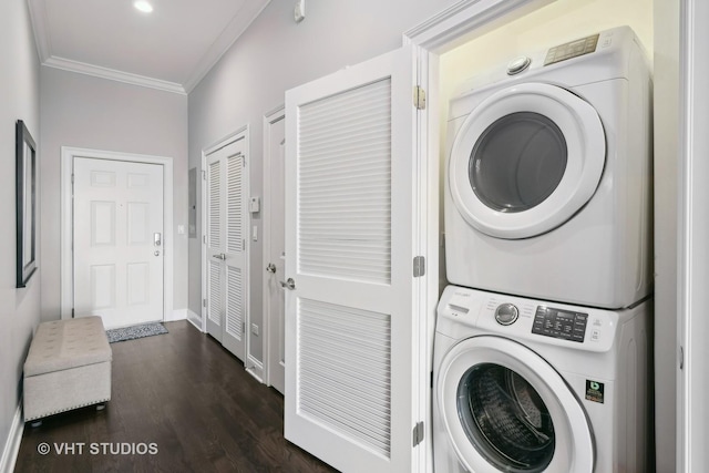 laundry room with dark wood-style floors, crown molding, stacked washing maching and dryer, laundry area, and baseboards