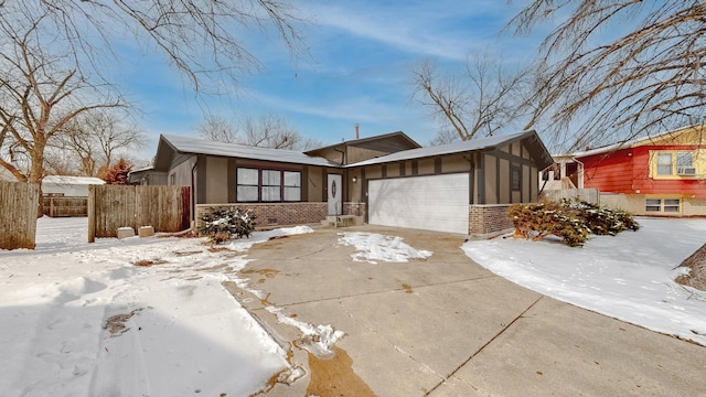 mid-century modern home with brick siding, stucco siding, fence, a garage, and driveway