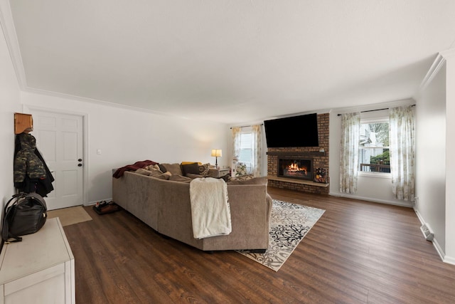 living room featuring baseboards, a brick fireplace, and dark wood-style floors