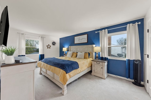 bedroom featuring light colored carpet and baseboards