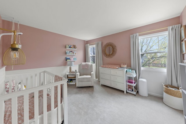bedroom featuring carpet floors and a nursery area