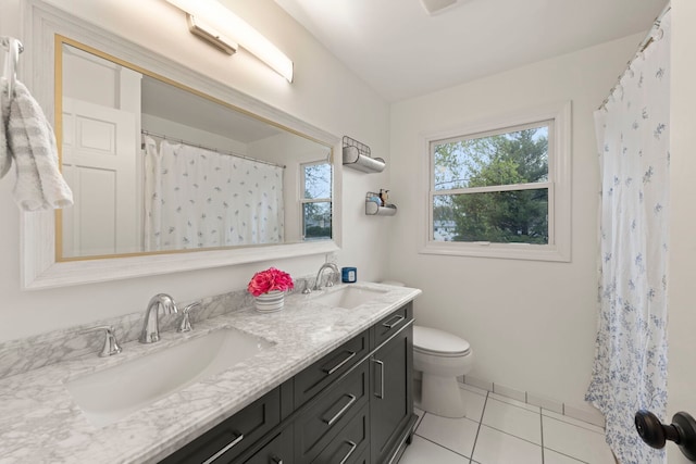 full bathroom featuring a sink, tile patterned flooring, toilet, and double vanity