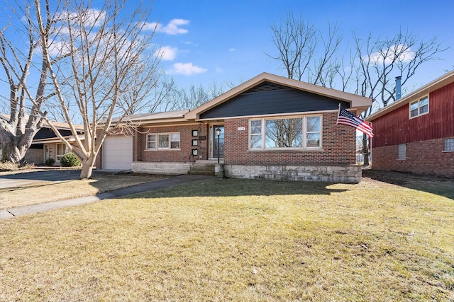 ranch-style home with a garage, a front yard, aphalt driveway, and brick siding