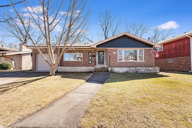 view of front facade featuring a garage, a front yard, aphalt driveway, and brick siding