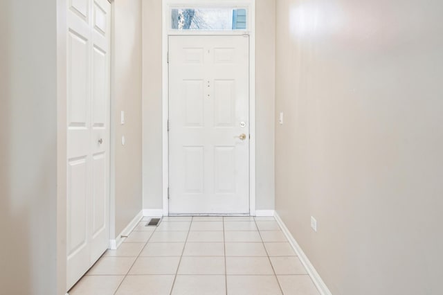 entrance foyer featuring light tile patterned floors and baseboards