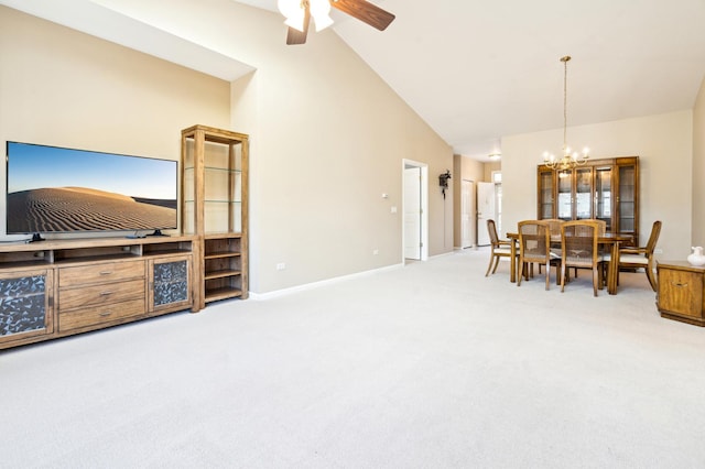 dining area with high vaulted ceiling, carpet, baseboards, and ceiling fan with notable chandelier