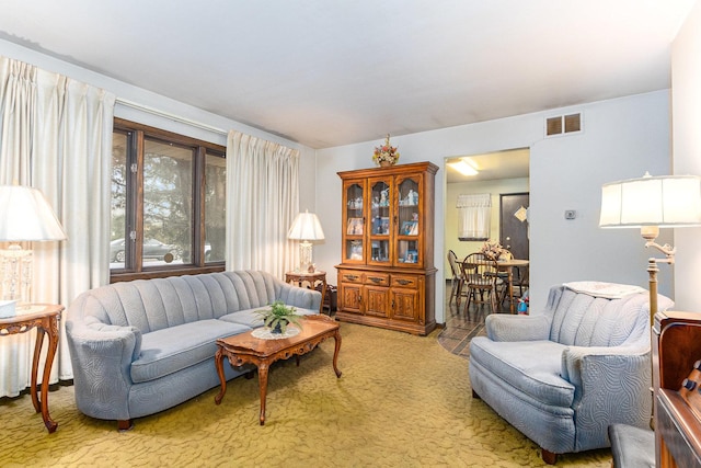 living room featuring visible vents and light colored carpet