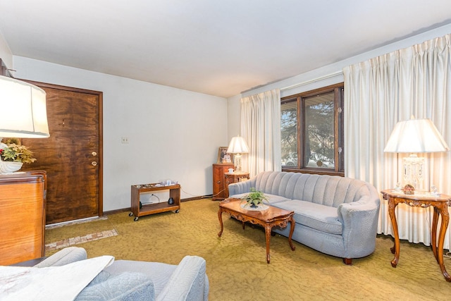 living area featuring carpet flooring and baseboards