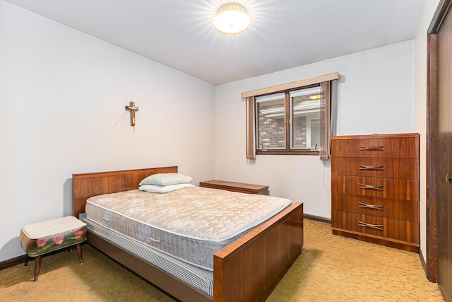 bedroom with light carpet and baseboards