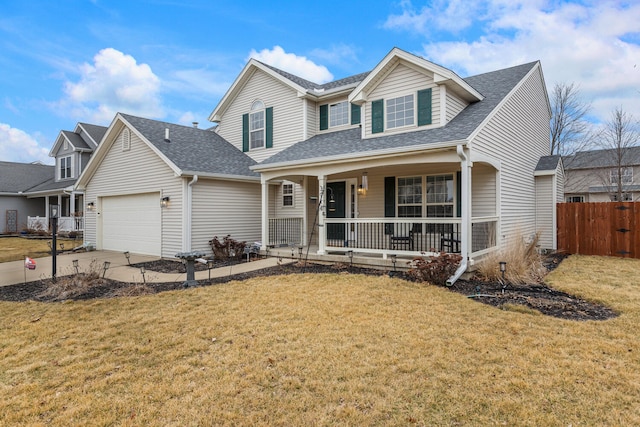 traditional-style house featuring driveway, a porch, an attached garage, fence, and a front lawn