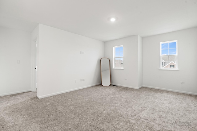 carpeted empty room with baseboards