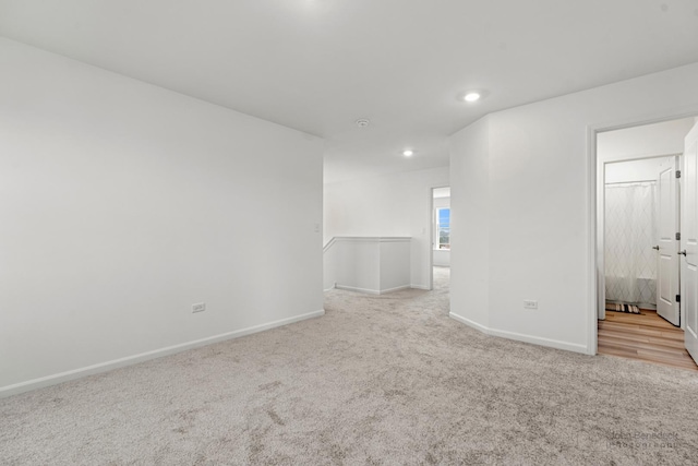 empty room with carpet floors, recessed lighting, and baseboards