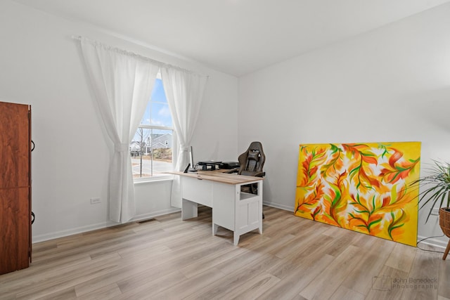 office area featuring baseboards, visible vents, and light wood-style floors