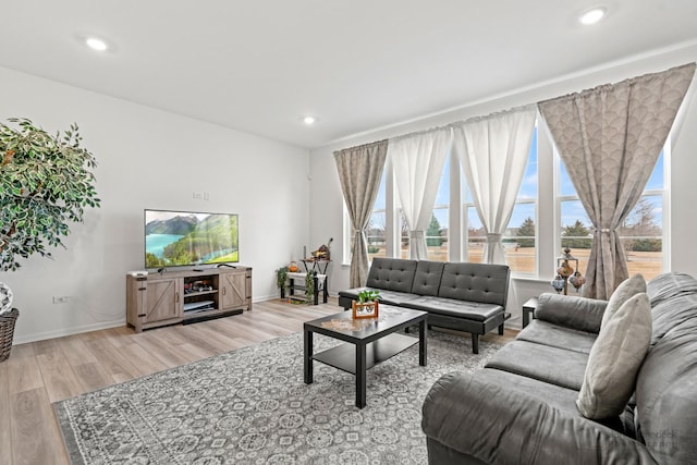 living room with baseboards, wood finished floors, and recessed lighting