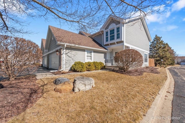 view of side of property featuring aphalt driveway