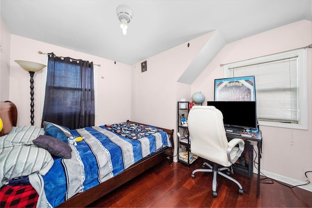 bedroom featuring vaulted ceiling, dark wood finished floors, and baseboards