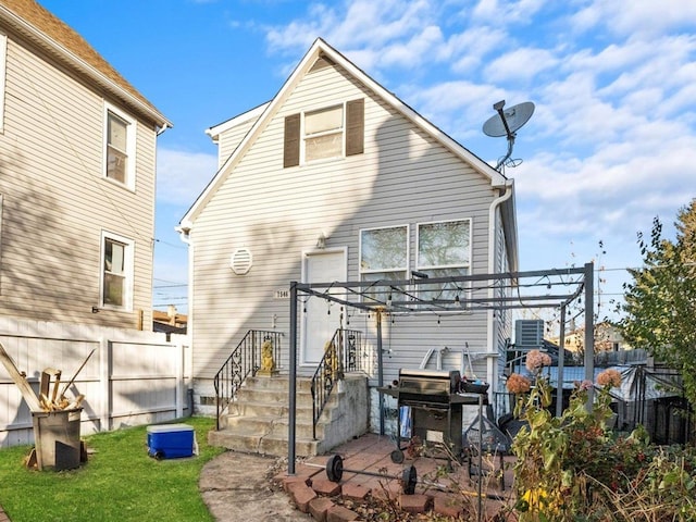 rear view of property featuring fence