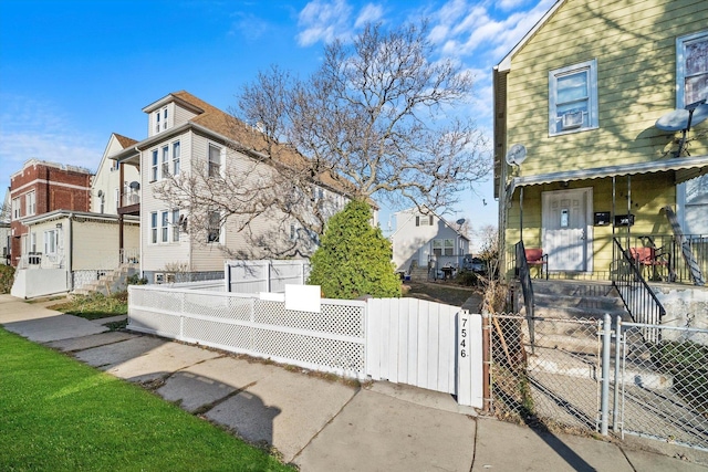 view of home's exterior featuring a fenced front yard, a residential view, and a gate