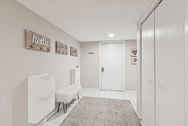 hall with light tile patterned floors