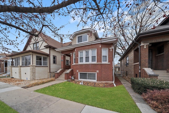 bungalow-style house featuring brick siding and a front lawn