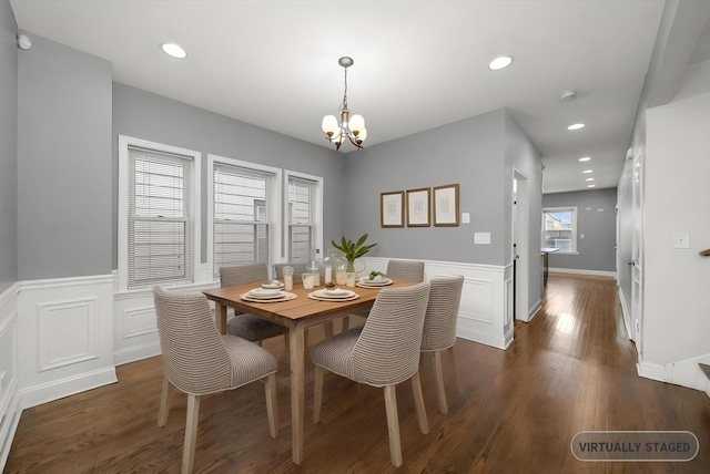 dining area with a chandelier, dark wood-type flooring, a wainscoted wall, and recessed lighting