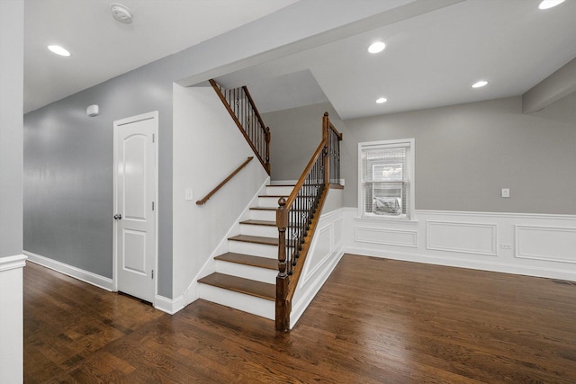 stairs with a wainscoted wall, wood finished floors, and recessed lighting