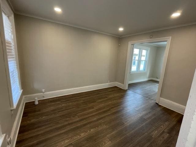 unfurnished room with ornamental molding, dark wood-type flooring, recessed lighting, and baseboards