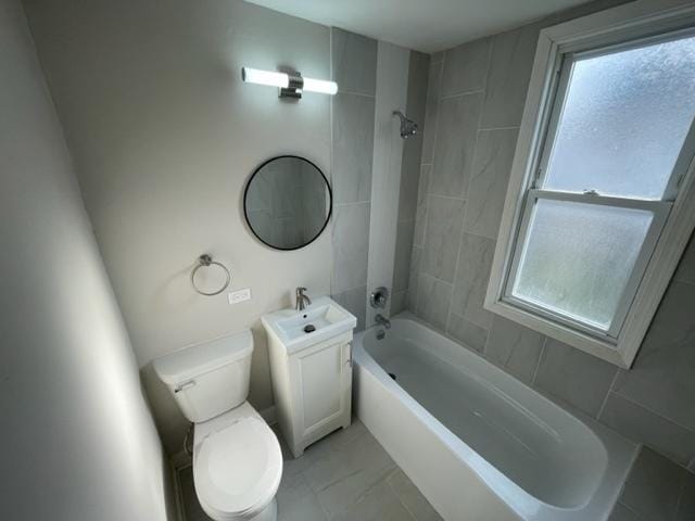 bathroom featuring a healthy amount of sunlight, shower / bathing tub combination, and toilet