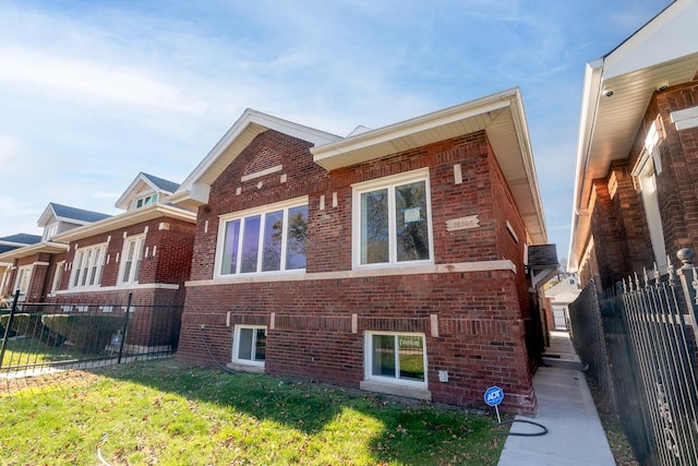 view of home's exterior with brick siding, a lawn, and fence