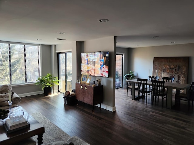 living room featuring dark wood-style flooring, recessed lighting, visible vents, and baseboards