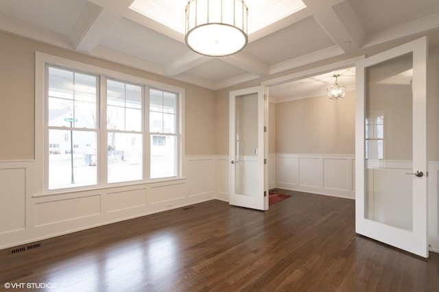 empty room with coffered ceiling, visible vents, french doors, beamed ceiling, and dark wood finished floors