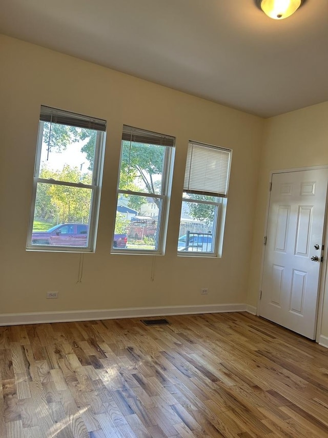 1234 W 49th Pl, Chicago, IL 60609 - empty room featuring visible vents, baseboards, and wood finished floors