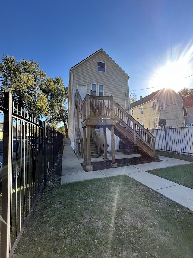 1234 W 49th Pl, Chicago, IL 60609 - rear view of house featuring stairs, a yard, and fence