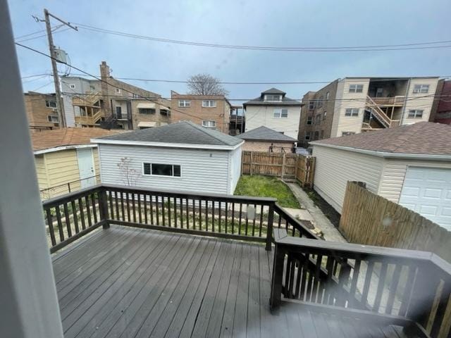 deck with an outbuilding and fence