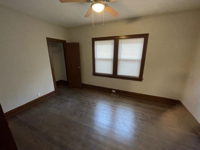 unfurnished room featuring ceiling fan, baseboards, and wood finished floors