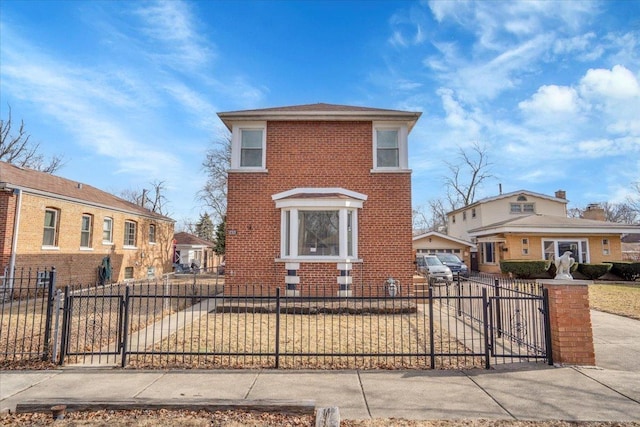 view of front facade with a fenced front yard, a gate, and brick siding