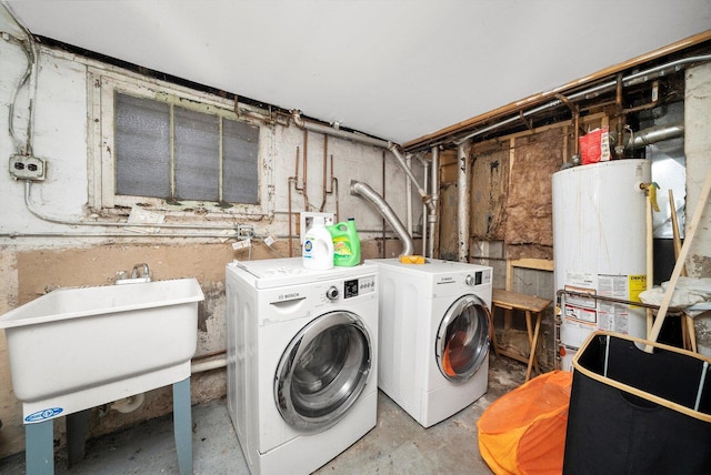 laundry area with a sink, laundry area, separate washer and dryer, and gas water heater