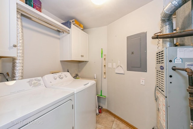 washroom with light tile patterned flooring, baseboards, cabinet space, electric panel, and washer and clothes dryer