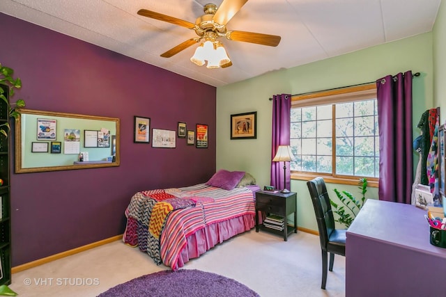 carpeted bedroom with a ceiling fan and baseboards