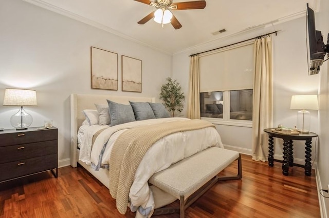 bedroom with ornamental molding, dark wood-style flooring, visible vents, and baseboards