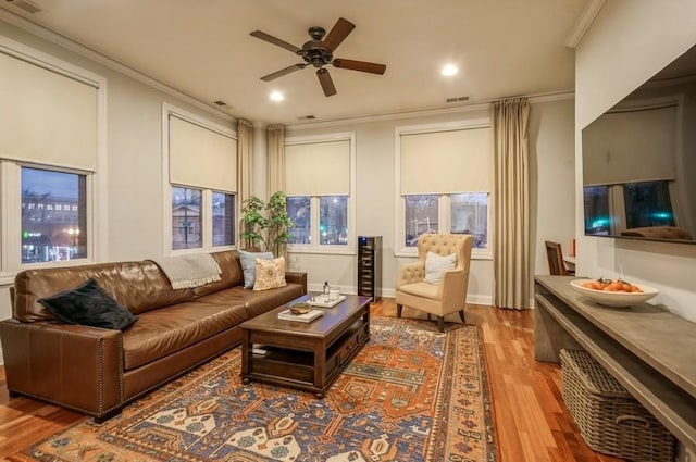 living area featuring a ceiling fan, ornamental molding, wood finished floors, and recessed lighting