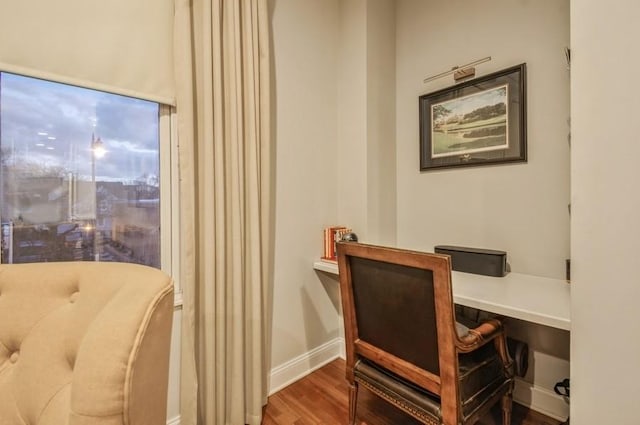 office area featuring baseboards and wood finished floors