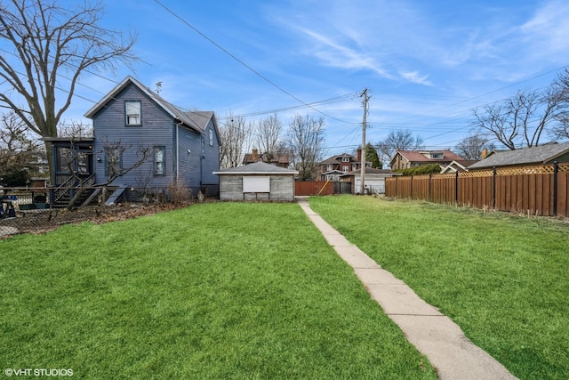 view of yard featuring an outbuilding and fence