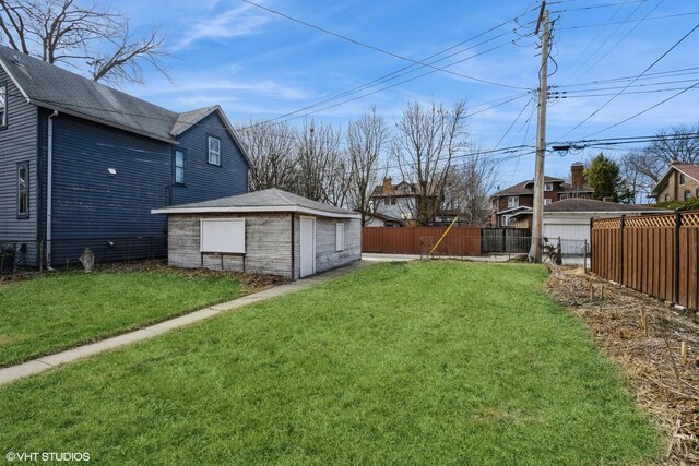 view of yard featuring fence and an outdoor structure