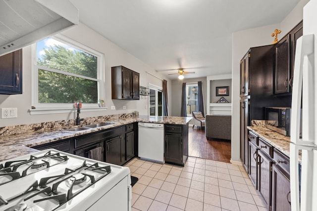 2031 Edinburgh Ln, Aurora, IL 60504 - kitchen featuring white appliances, a peninsula, light tile patterned floors, a ceiling fan, and light stone countertops