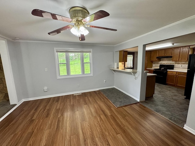 unfurnished living room with crown molding and dark wood-style flooring